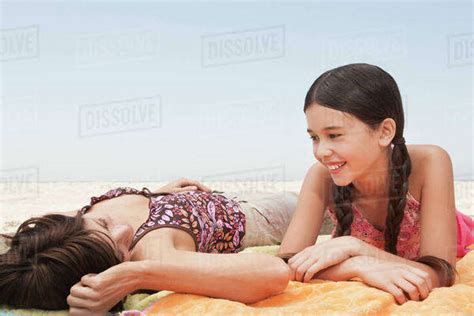 Mother And Daughter Relaxing On Beach Stock Photo Dissolve