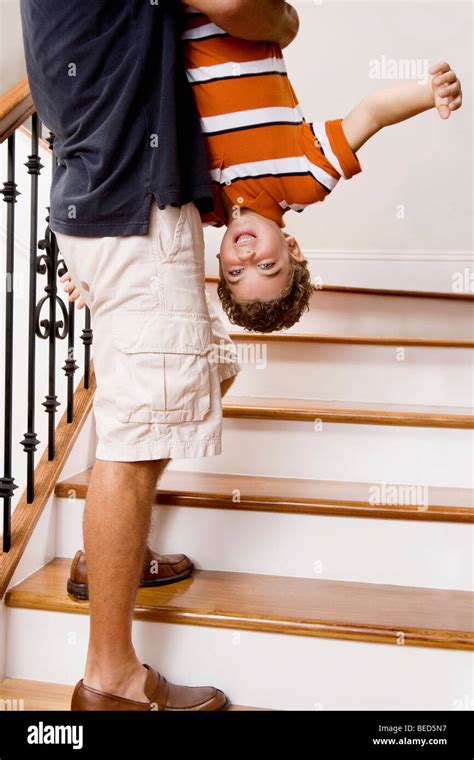 Father Carrying Child Upside Down Hi Res Stock Photography And Images