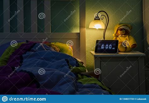 Little Girl Sleeping In Bed Alarm Clock At 6 Am In The Morning Stock