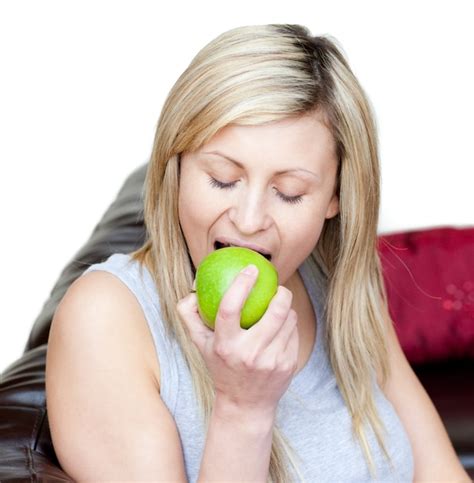 Premium Photo Cheerful Woman Eating An Apple