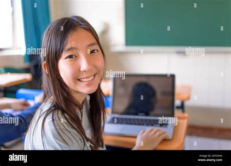 Happy Asian Student Girl Using Laptop In Classroom Stock Photo Alamy