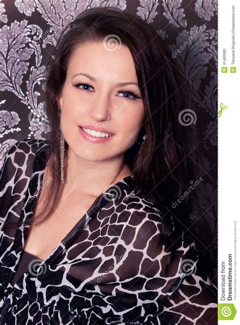 Portrait Of The Beautiful Young Brunette Smile Girl In Black Dress