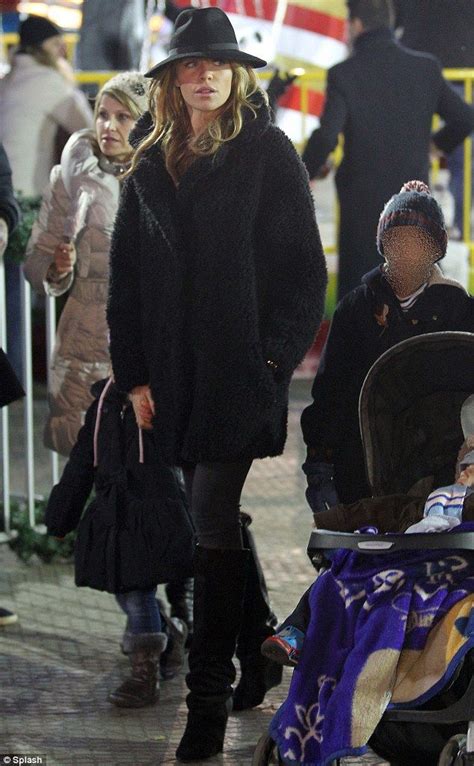 Abbey Clancy Steps Out In Trilby And Fluffy Coat At Winter Wonderland