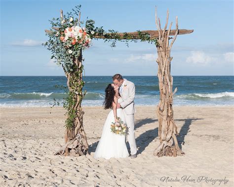 Beach Wedding Bride And Groom Portrait Under Their Ceremony Arbor