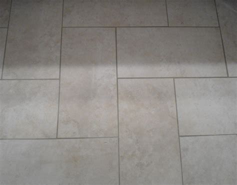 This tile is a dramatic brown. herringbone plank tiles | Kitchen floor tile patterns ...