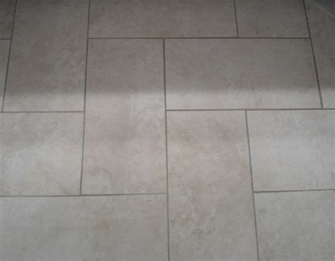 This tile is a dramatic brown. herringbone plank tiles | Kitchen floor tile patterns ...