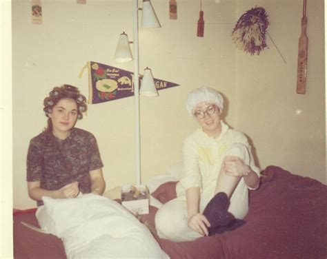 1960s College Sorority Girls Hair In Curlers Shower Cap Sitting On Bed In Dorm Room Cheerleader