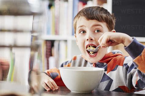 Young Boy Eating Breakfast Stock Photo