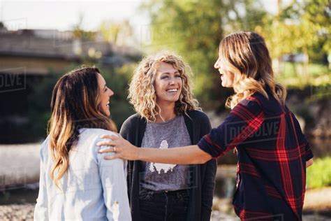 Happy Female Friends Talking Standing Outdoors Stock Photo Dissolve