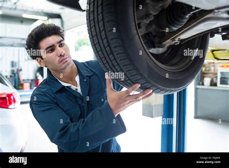 Mechanic Fixing A Car Wheel Stock Photo Alamy