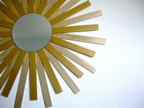 A Sunburst Shaped Mirror Hanging On The Wall