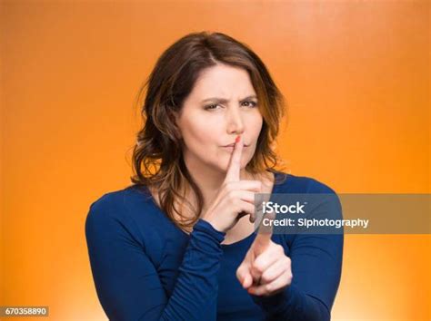 Serious Mature Woman Placing Finger Hand On Lips Shhh Gesture Stock