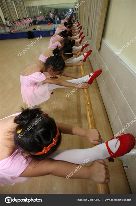 Young Chinese Girls Bend Bodies Stretch Legs Ballet Barre Learn Stock