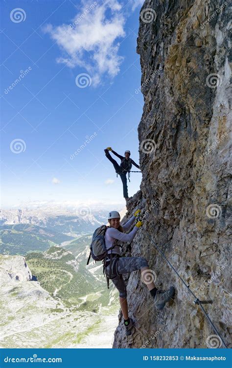 Attractive Female Climbers On A Steep Via Ferrata In The Italian