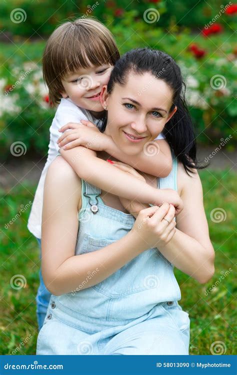 Loving Son Hugging His Happy Mother In Park Stock Photo Image Of