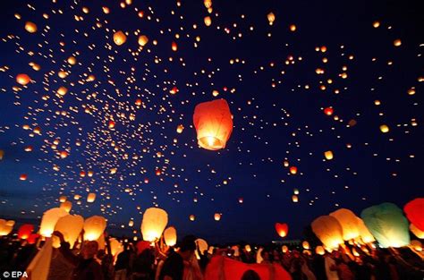 Multicolored chinese air lanterns fly in the night sky, picture on a black background. Twinkle twinkle little Chinese lanterns: 8,000 flying ...