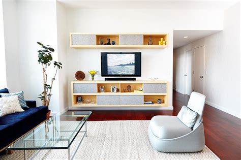 Clutter can build up quickly in a space that's used by the whole household living rooms are multifunctional spaces, so they need lighting for all the different tasks they need to perform. Bright Living Room With Floating Entertainment Center | HGTV