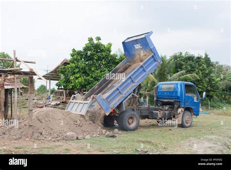 Blue Dump Truck Unloading Soil At Construction Site Stock Photo Alamy