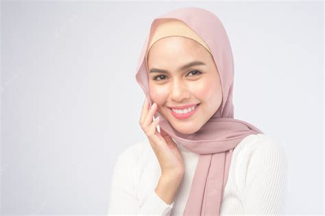Premium Photo A Portrait Of Young Smiling Muslim Woman Wearing A Pink Hijab Over White