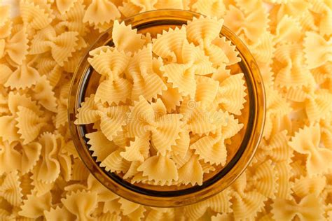 Dried Farfalle Rigate Italian Pasta In A Yellow Round Bowl Ready To Be
