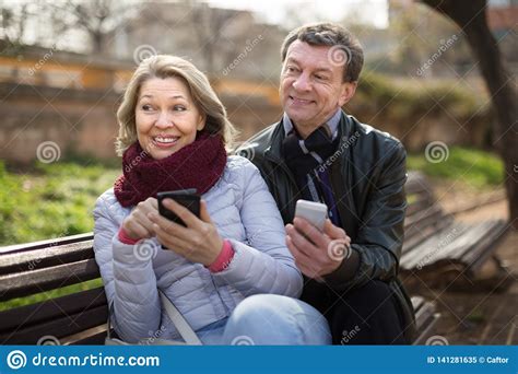 Smiling Mature Couple Exchanging Phone Numbers Stock Image Image Of