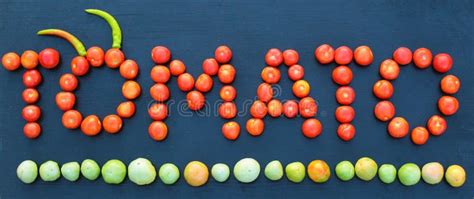 Word Tomato Written With Green And Red Tomatoes On Wooden Board Stock