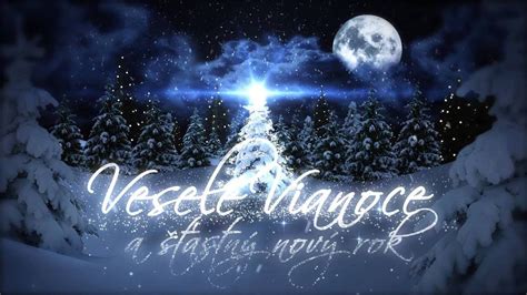 A Christmas Card With The Words Veselt Language And Snow Covered Trees