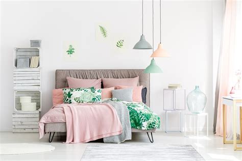 It is accompanied by wooden nightstands and a leather chair with orange printed pillow. How to Decorate a Pink Bedroom