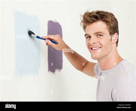 Young Man Painting A Wall Stock Photo Alamy