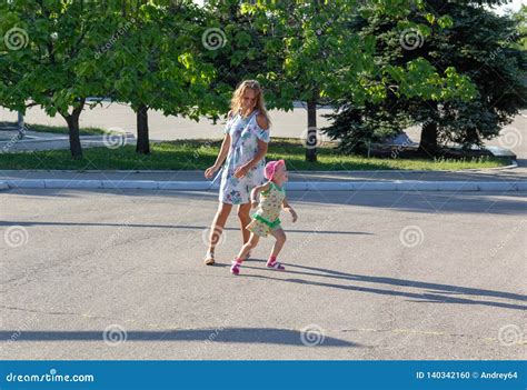Baby Runs Away From Mom Mom Runs For The Child Stock Photo Image Of