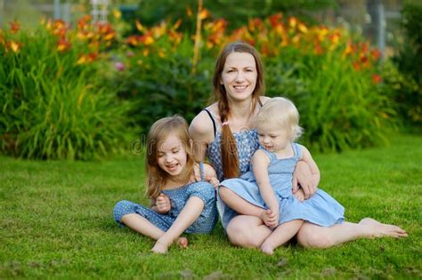 Young Mother And Her Two Daughters Stock Photo Image Of Nice Flowers