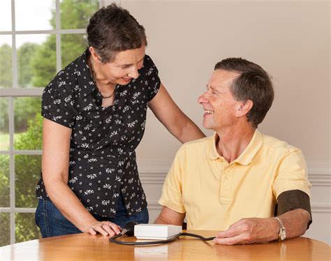 Senior Man Taking Blood Pressure With Wife Net Health Book
