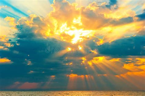 Golden Rays Of The Sun Breaking Through The Storm Clouds Stock Photo