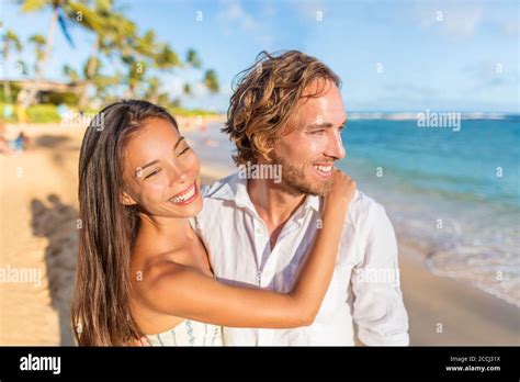 Honeymoon Beach Vacation Couple In Love Hugging Young Interracial Lovers Relaxing On Beach At