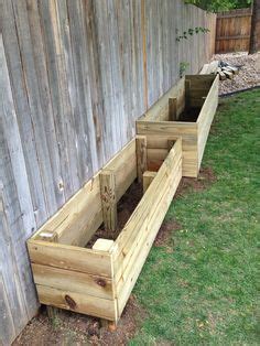But this builder went with landscaping timbers. Image result for raised garden beds along fence line ...