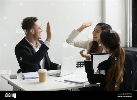 Colleagues Giving High Five Celebrating Shared Success Stock Photo Alamy