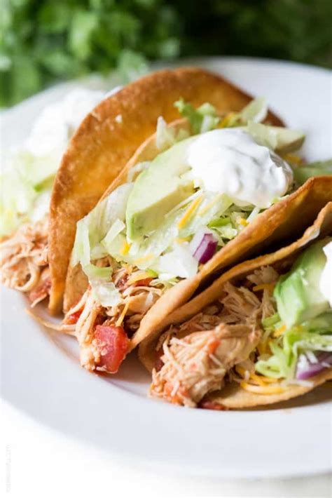 This spicy chicken taco recipe gets fresh orange flavor from both the crema and crunchy slaw toppings. Slow Cooker Mexican Shredded Chicken Tacos - Tastes Lovely