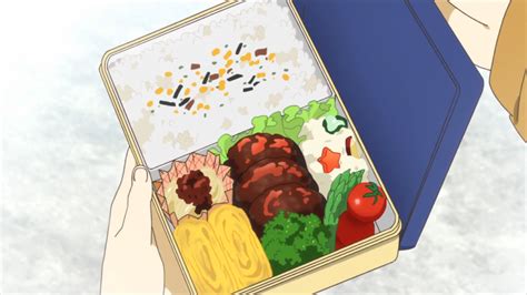A Bento With Hamburger Steak Potato Salad Vegetables And Tamagoyaki