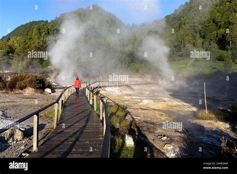lagoa das furnas e fumarolas woman walking on a site of bubbling hot springs and fumaroles on
