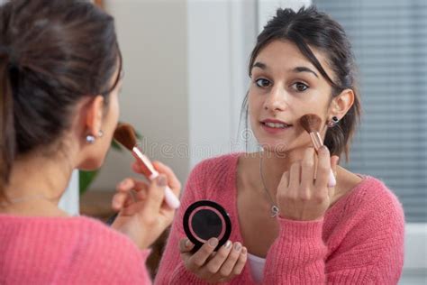 Young Brunette Woman Putting Makeup In The Mirror Stock Image Image