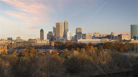 The city's skyline at sunset, seen from trees, Downtown Indianapolis, Indiana Aerial Stock Photo ...