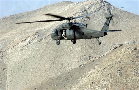 A Us Army Usa Uh 60 Black Hawk Helicopter Is Used To Deliver Soldier