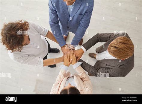 Top View Of A Group Of Business People Standing Together And Joining