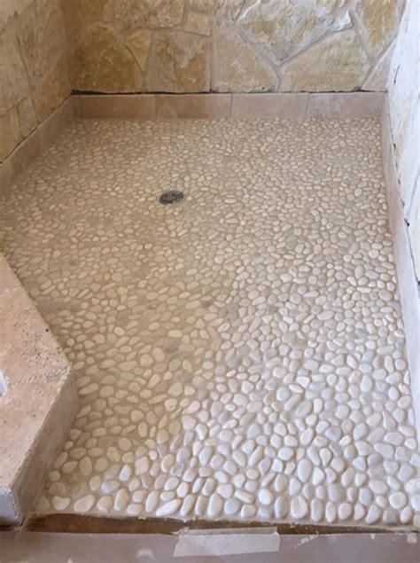 White Pebble Tile Shower Pan With Stone Walls Tilehub