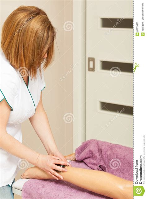 Masseuse Doing Legs Massage With Hot Stones Stock Image Image Of Woman Hygiene 83135479
