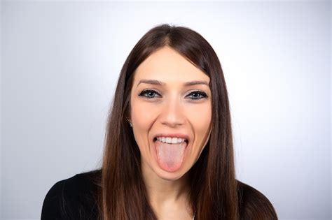 Premium Photo Funny Immage Of A Smiling Girl Showing Tongue Portrait Of A Young Caucasian