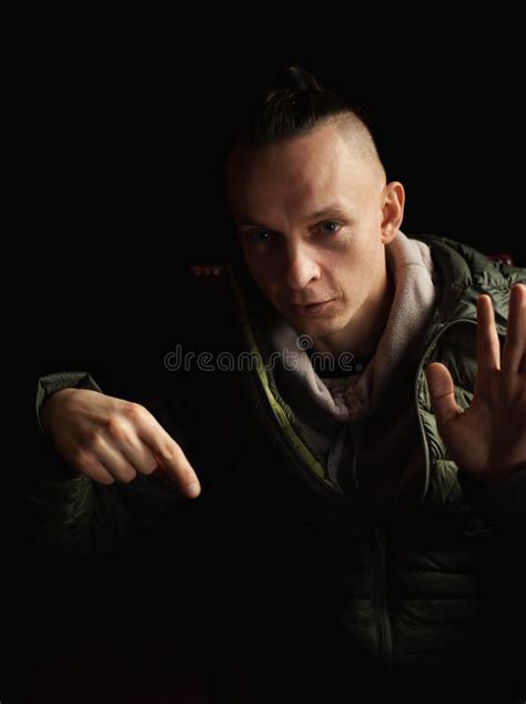 A Man Speaks And Explains On A Dark Background A Middle Aged Man With
