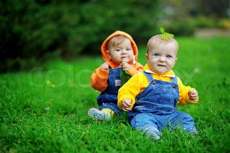 You can help to expand this page by adding an image or additional information. Cute twins babies sitting on fresh green grass in park | Stock Photo | Colourbox