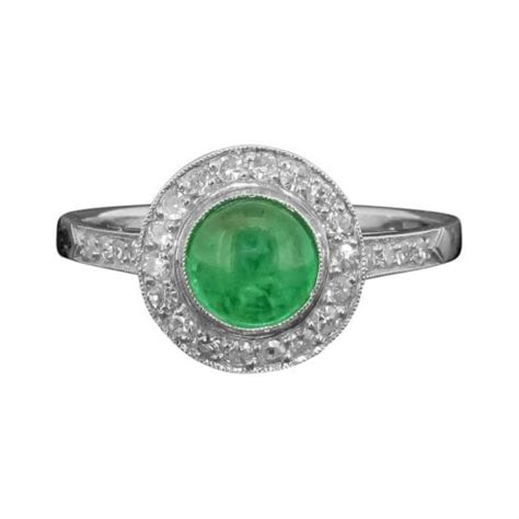 The plaque shape of this ring is a typical art deco design, emblematic of the era in which this piece was made. Antique Platinum Emerald and Diamond Art Deco Cluster Ring ...
