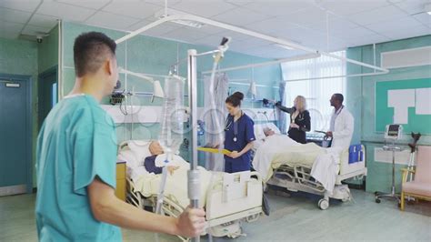 Busy Doctors And Nurses Taking Care Of Patients On A Hospital Ward